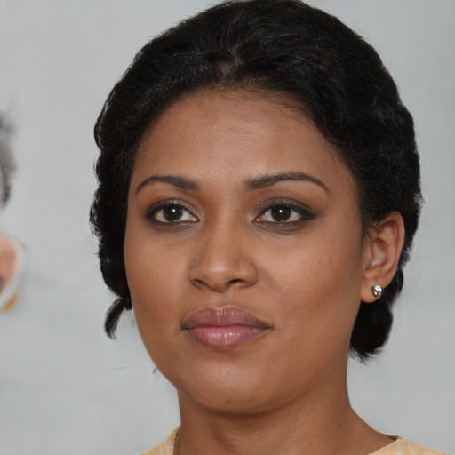 Joyful black young-adult female with medium  brown hair and brown eyes
