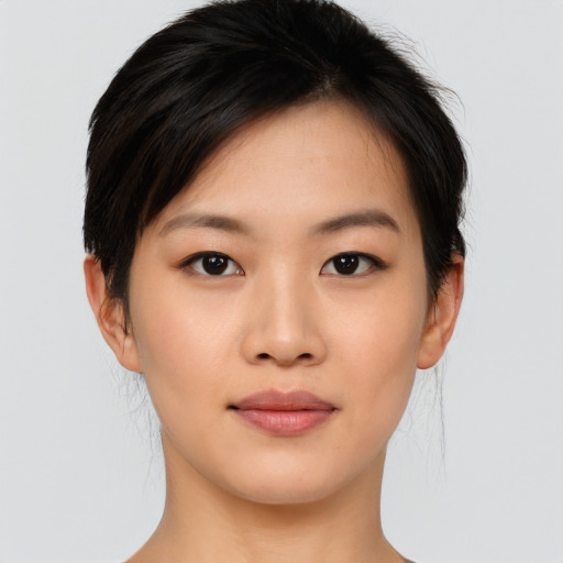 Joyful asian young-adult female with short  brown hair and brown eyes