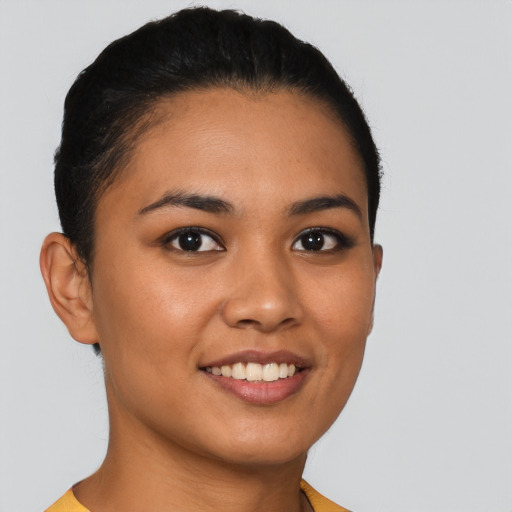 Joyful latino young-adult female with short  brown hair and brown eyes