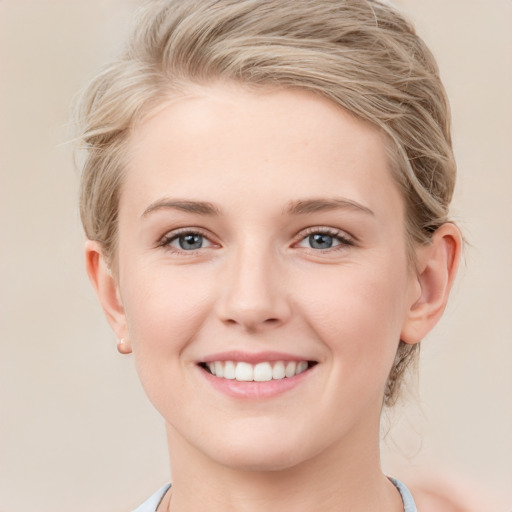 Joyful white young-adult female with medium  brown hair and blue eyes