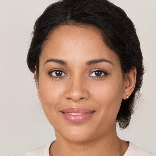 Joyful latino young-adult female with medium  brown hair and brown eyes