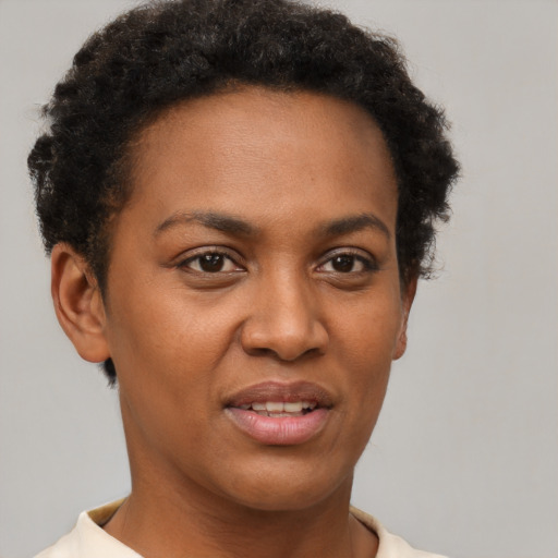 Joyful black young-adult female with short  brown hair and brown eyes