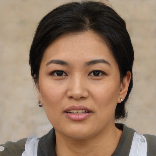 Joyful asian young-adult female with medium  black hair and brown eyes