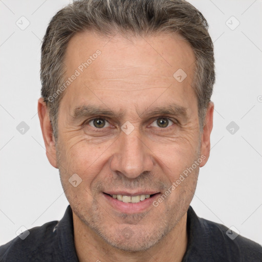 Joyful white middle-aged male with short  brown hair and brown eyes