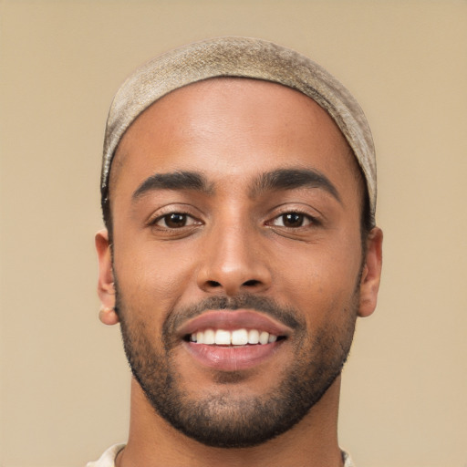 Joyful white young-adult male with short  black hair and brown eyes