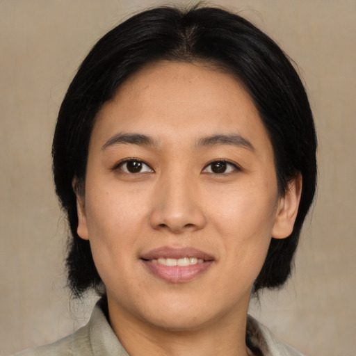 Joyful asian young-adult female with medium  black hair and brown eyes