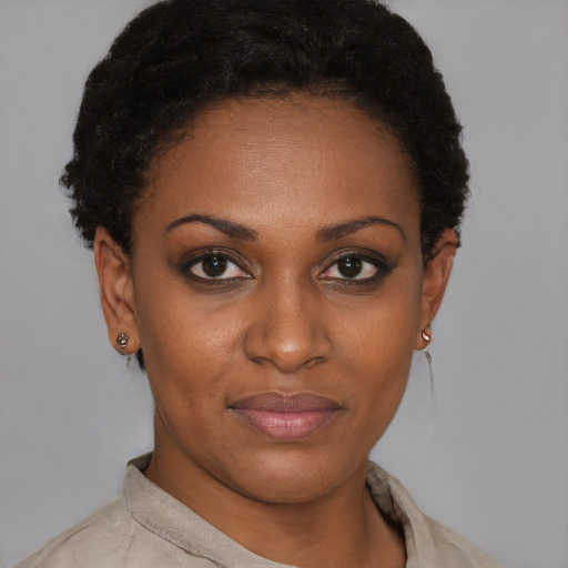 Joyful black young-adult female with short  brown hair and brown eyes