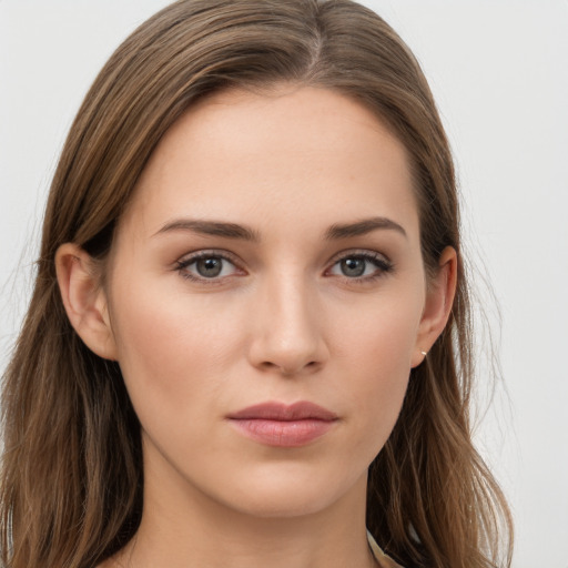 Joyful white young-adult female with long  brown hair and grey eyes