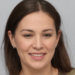 Joyful white adult female with medium  brown hair and brown eyes