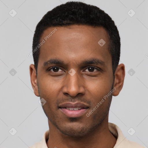 Joyful black young-adult male with short  black hair and brown eyes