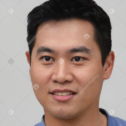 Joyful asian young-adult male with short  black hair and brown eyes