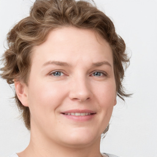 Joyful white young-adult female with medium  brown hair and blue eyes