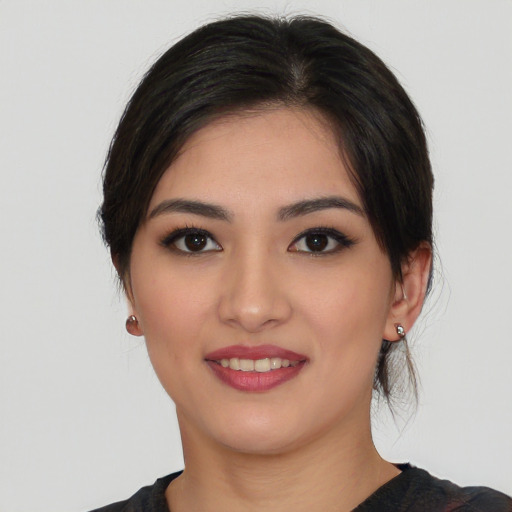 Joyful asian young-adult female with medium  black hair and brown eyes