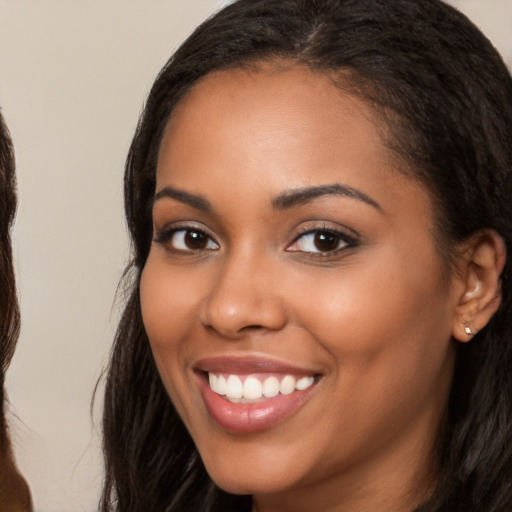 Joyful latino young-adult female with long  brown hair and brown eyes