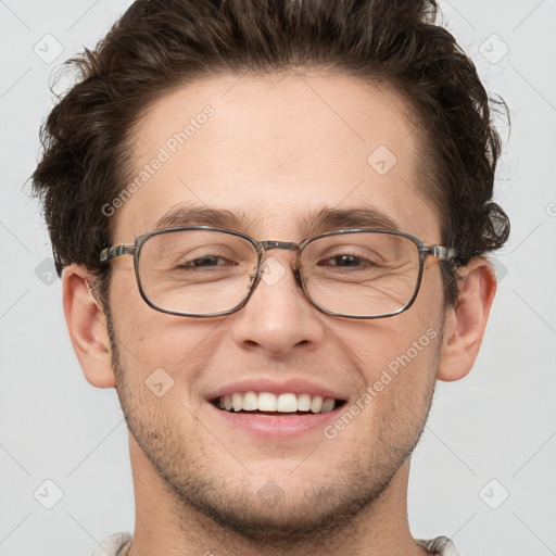 Joyful white adult male with short  brown hair and grey eyes