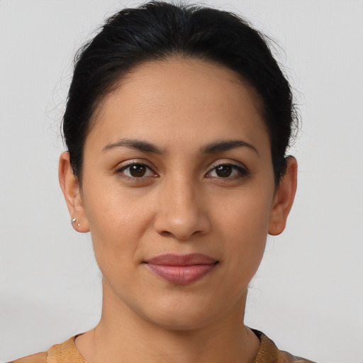 Joyful latino young-adult female with short  brown hair and brown eyes