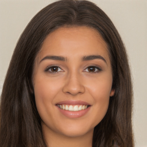 Joyful latino young-adult female with long  brown hair and brown eyes