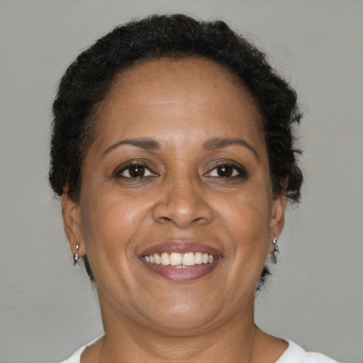 Joyful black adult female with short  brown hair and brown eyes
