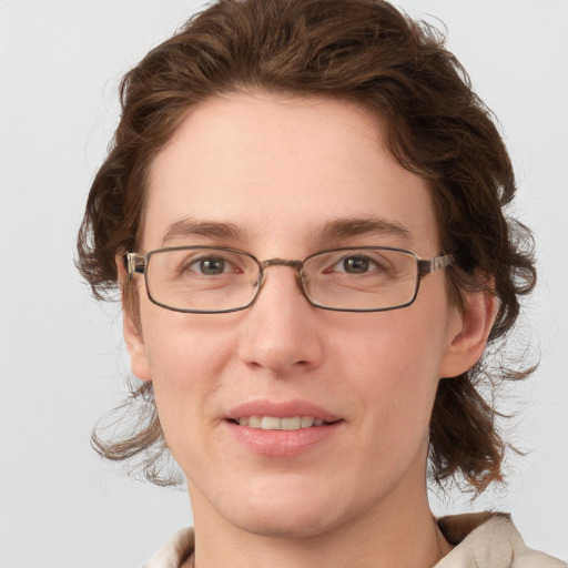 Joyful white young-adult female with medium  brown hair and grey eyes