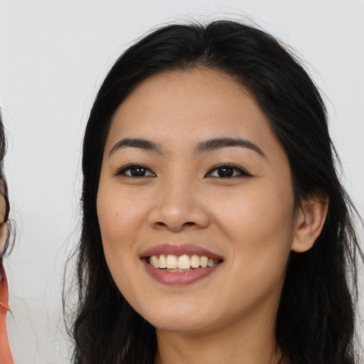 Joyful asian young-adult female with long  brown hair and brown eyes