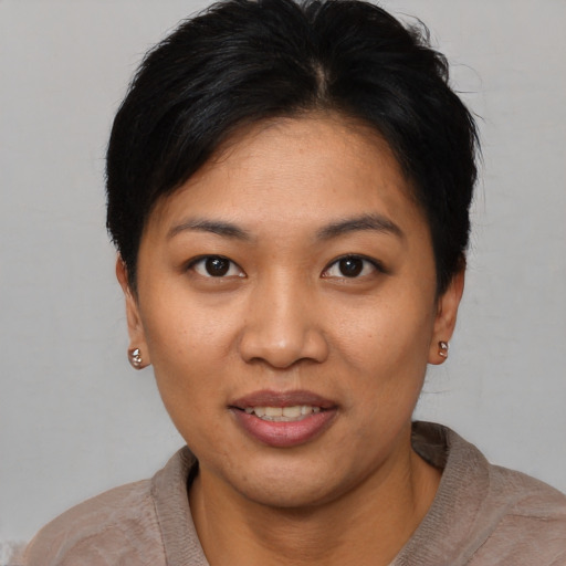 Joyful asian young-adult female with short  black hair and brown eyes