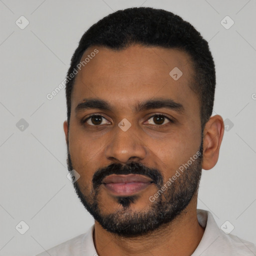 Joyful black young-adult male with short  black hair and brown eyes