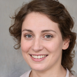 Joyful white young-adult female with medium  brown hair and blue eyes