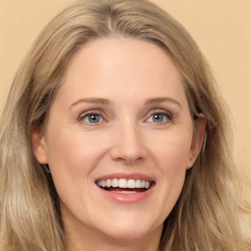 Joyful white adult female with long  brown hair and grey eyes