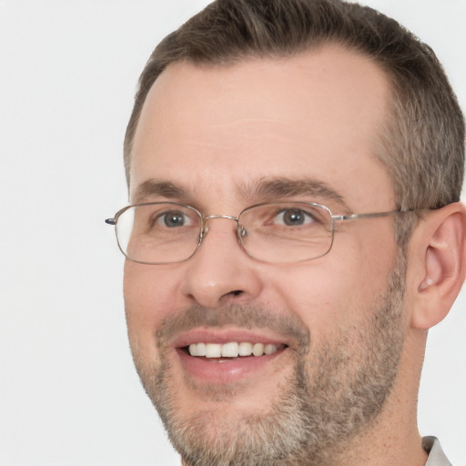 Joyful white adult male with short  brown hair and brown eyes