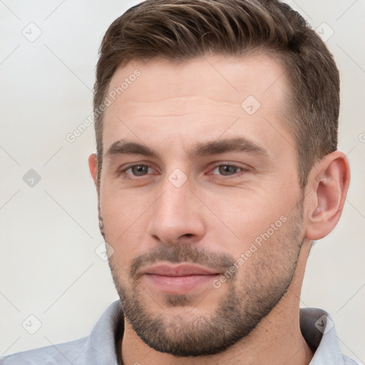 Joyful white young-adult male with short  brown hair and brown eyes