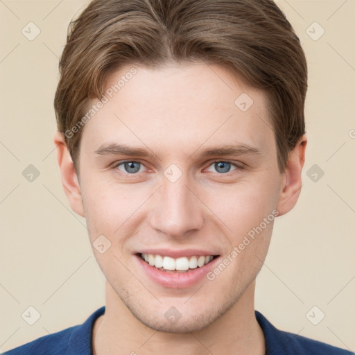 Joyful white young-adult male with short  brown hair and grey eyes