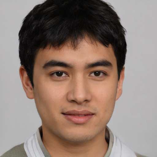 Joyful asian young-adult male with short  brown hair and brown eyes