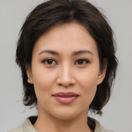 Joyful asian young-adult female with medium  brown hair and brown eyes