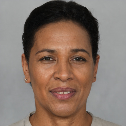 Joyful latino adult female with short  black hair and brown eyes