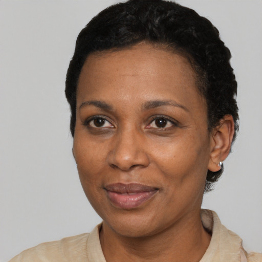 Joyful black adult female with short  black hair and brown eyes