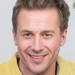 Joyful white adult male with short  brown hair and grey eyes