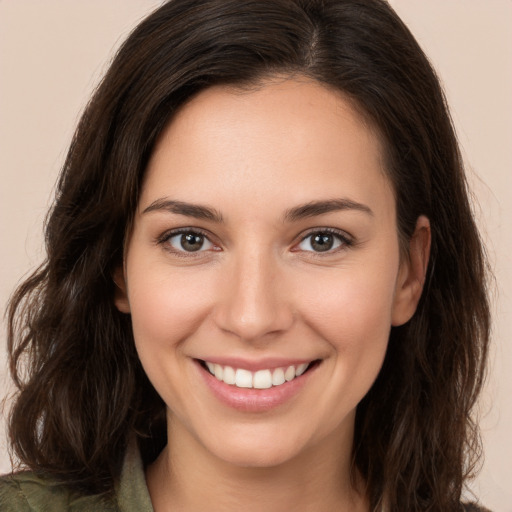 Joyful white young-adult female with medium  brown hair and brown eyes