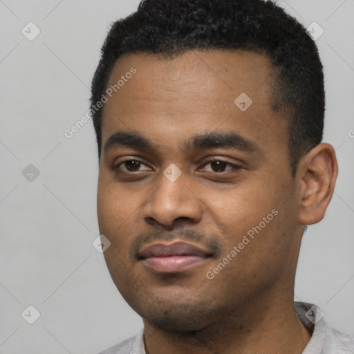 Joyful black young-adult male with short  black hair and brown eyes