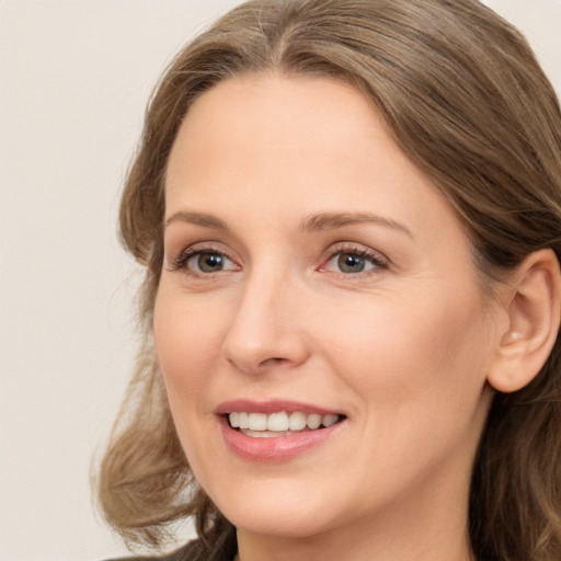 Joyful white adult female with long  brown hair and brown eyes