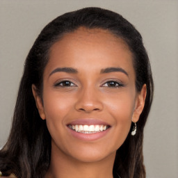 Joyful latino young-adult female with long  brown hair and brown eyes