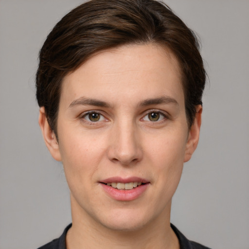 Joyful white young-adult female with short  brown hair and grey eyes