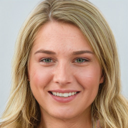 Joyful white young-adult female with long  brown hair and blue eyes