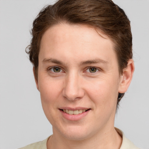 Joyful white young-adult female with short  brown hair and green eyes