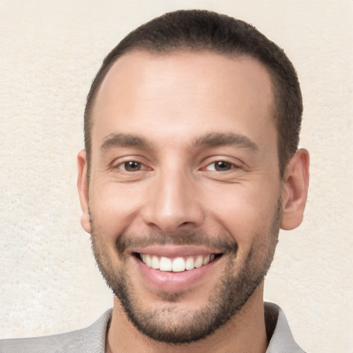 Joyful white young-adult male with short  brown hair and brown eyes