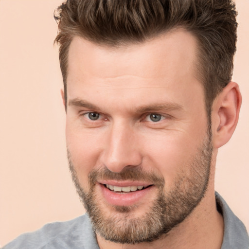 Joyful white adult male with short  brown hair and brown eyes