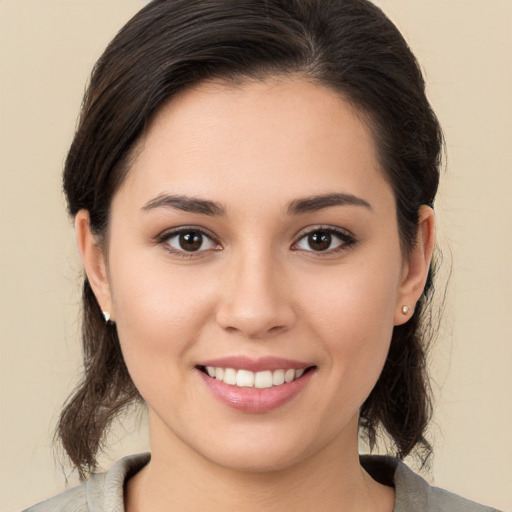 Joyful white young-adult female with medium  brown hair and brown eyes