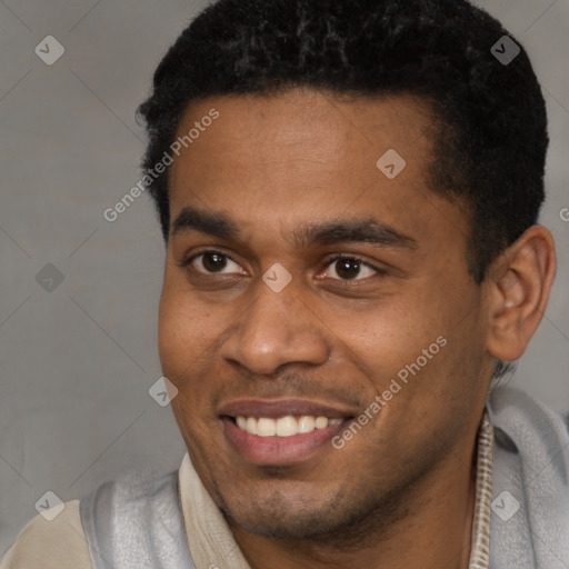 Joyful latino young-adult male with short  black hair and brown eyes