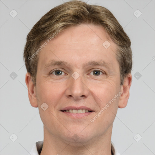 Joyful white adult male with short  brown hair and grey eyes