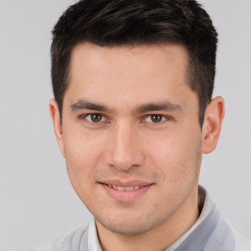 Joyful white young-adult male with short  brown hair and brown eyes