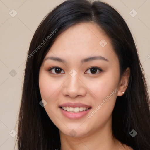 Joyful asian young-adult female with long  brown hair and brown eyes